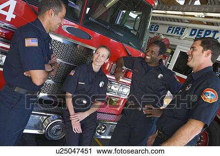 Four firefighters talking by fire engine View Large Photo Image Stock Image - Four firefighters talking by fire engine. Fotosearch