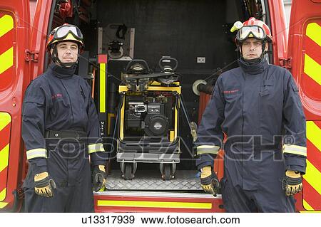Two rescue workers standing by open back door of rescue vehicle View Large Photo Image Stock Photo - Two rescue workers standing by open back door of rescue vehicle. Fotosearch