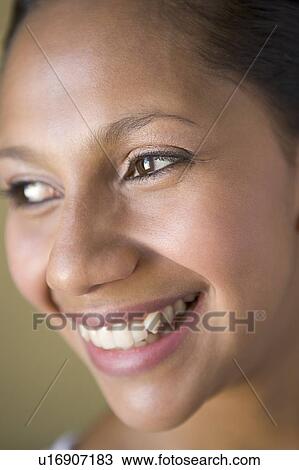 Stock Image - Head shot of woman smiling. Fotosearch