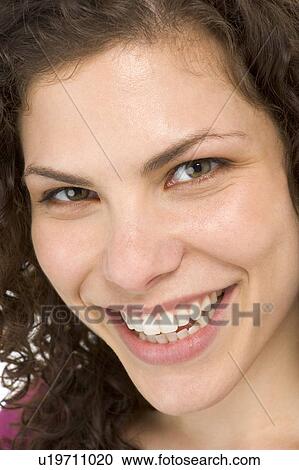 Stock Image - Head shot of woman smiling. Fotosearch