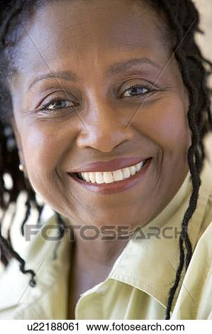 Stock Image - Head shot of woman smiling. Fotosearch