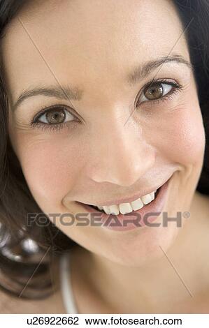 Stock Image - Head shot of woman smiling. Fotosearch
