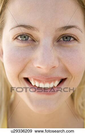 Stock Photo - Head shot of woman smiling. Fotosearch