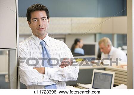 Businessman standing in cubicle View Large Photo Image Stock Photograph - Businessman standing in cubicle. Fotosearch