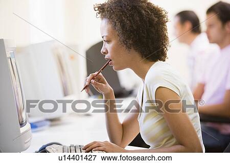 Woman in computer room looking at monitor and thinking View Large Photo Image Stock Photo - Woman in computer room looking at monitor and thinking. Fotosearch