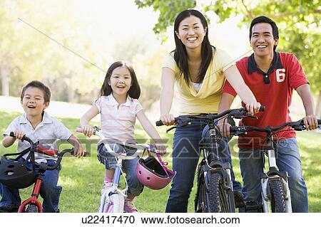 Family on bikes outdoors smiling View Large Photo Image Stock Image - Family on bikes outdoors smiling. Fotosearch