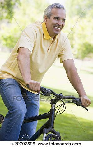Man on bike outdoors smiling View Large Photo Image Stock Photography - Man on bike outdoors smiling. Fotosearch