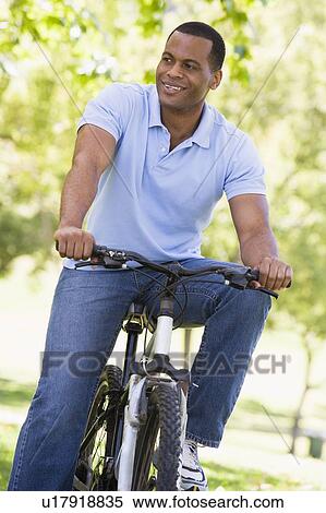 Man outdoors on bike smiling View Large Photo Image Stock Photography - Man outdoors on bike smiling. Fotosearch