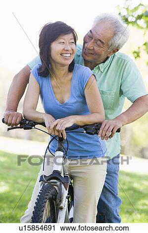 Stock Image - Mature couple bike riding.. Fotosearch