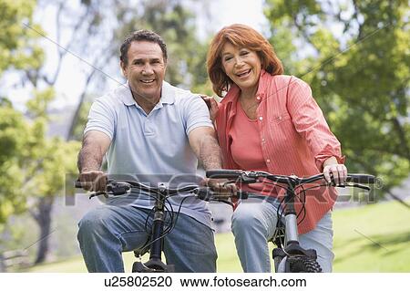Mature couple bike riding. View Large Photo Image Stock Image - Mature couple bike riding.. Fotosearch