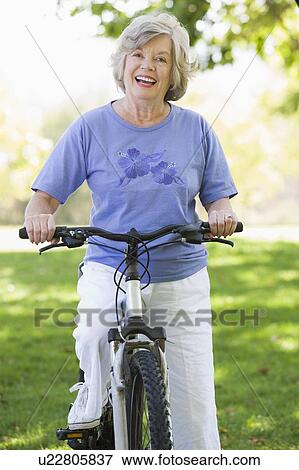 Stock Photo - Senior woman on a bicycle. Fotosearch
