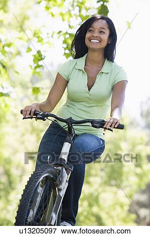 Woman on bicycle smiling View Large Photo Image Stock Photo - Woman on bicycle smiling. Fotosearch