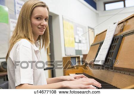 Female student learning piano in classroom View Large Photo Image Stock Photo - Female student learning piano in classroom. Fotosearch