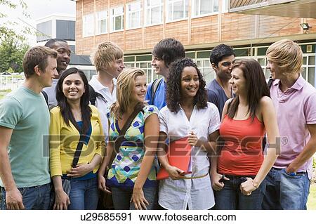 Group of students outdoors looking at camera smiling View Large Photo Image Stock Image - Group of students outdoors looking at camera smiling. Fotosearch