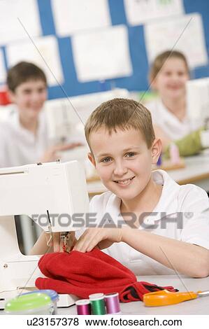 Stock Photo - Male student using sewing machine. Fotosearch