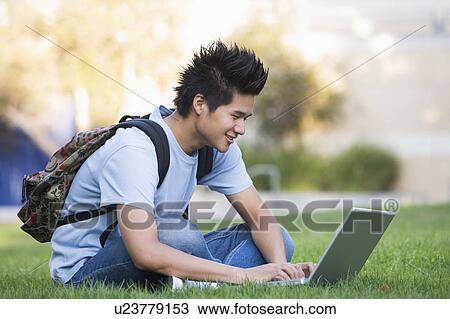 Man outdoors sitting on grass with laptop (selective focus) View Large Photo Image Stock Image - Man outdoors sitting on grass with laptop (selective focus). Fotosearch
