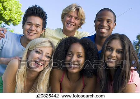 Six people outdoors huddling over camera View Large Photo Image Stock Image - Six people outdoors huddling over camera. Fotosearch
