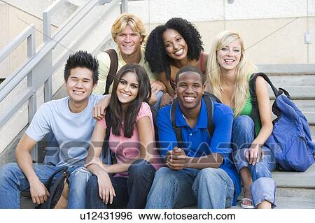 Stock Photograph - Six people sitting on staircase outdoors smiling. Fotosearch