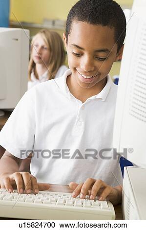 Student at computer terminal typing with student in background (selective focus) View Large Photo Image Stock Image - Student at computer terminal typing with student in background (selective focus). Fotosearch