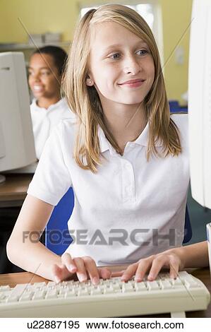Student at computer terminal typing with student in background (selective focus) View Large Photo Image Stock Photography - Student at computer terminal typing with student in background (selective focus). Fotosearch