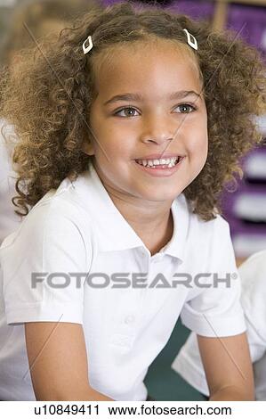 Student in class sitting on floor smiling (selective focus) View Large Photo Image Stock Image - Student in class sitting on floor smiling (selective focus). Fotosearch