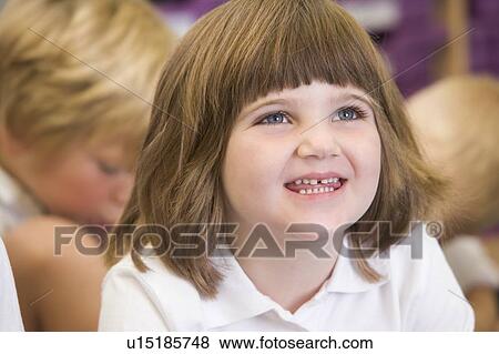Student in class sitting on floor with students in background (selective focus) View Large Photo Image Stock Photo - Student in class sitting on floor with students in background (selective focus). Fotosearch