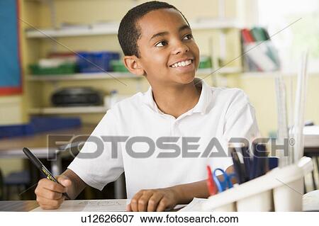 Stock Photo - Student in class taking notes. Fotosearch