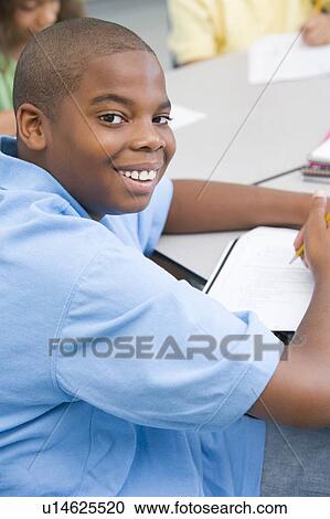 Student in class writing (selective focus) View Large Photo Image Stock Image - Student in class writing (selective focus). Fotosearch