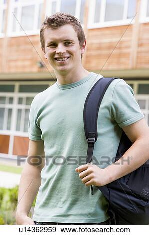 Student standing outdoors smiling View Large Photo Image Stock Photo - Student standing outdoors smiling. Fotosearch