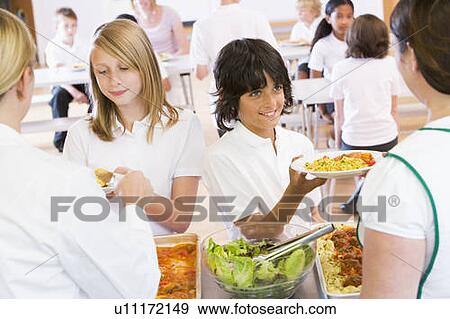 Stock Photo - Students in cafeteria line being served by lunch ladies. Fotosearch