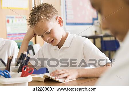Stock Photo - Students in class reading books (selective focus). Fotosearch