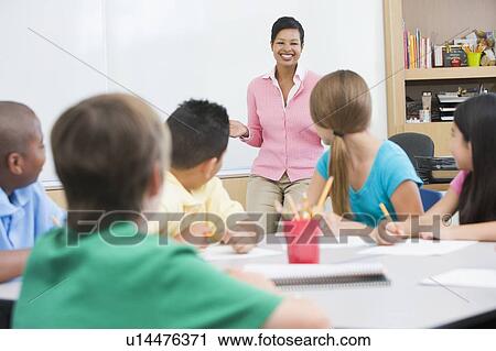 Students in class with teacher lecturing (selective focus) View Large Photo Image Stock Image - Students in class with teacher lecturing (selective focus). Fotosearch