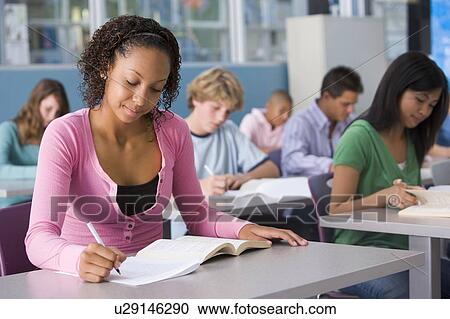 Stock Image - Students studying in geography class. Fotosearch