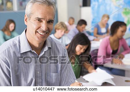 Stock Photo - Students studying in geography class with teacher. Fotosearch