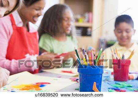 Teacher and students in art class with supplies in foreground (selective focus) View Large Photo Image Stock Image - Teacher and students in art class with supplies in foreground (selective focus). Fotosearch