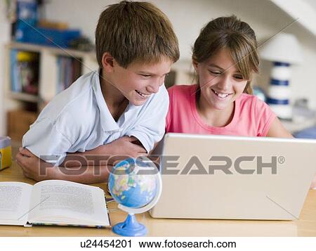 Boy And Girl Doing Their Homework On A Laptop View Large Photo Image Stock Image - Boy And Girl Doing Their Homework On A Laptop. Fotosearch