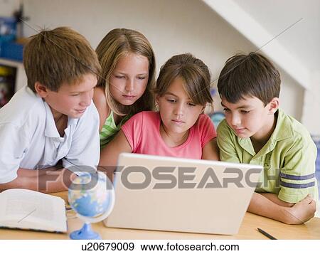 Group Of Young Children Doing Their Homework On A Laptop View Large Photo Image Stock Photo - Group Of Young Children Doing Their Homework On A Laptop. Fotosearch