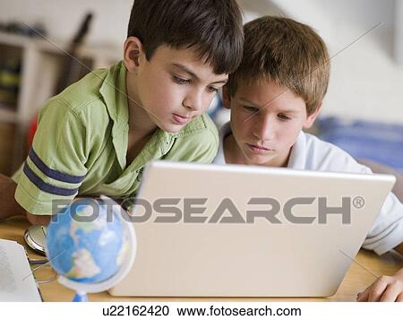 Two Young Boys Using A Laptop At Home View Large Photo Image Stock Image - Two Young Boys Using A Laptop At Home. Fotosearch