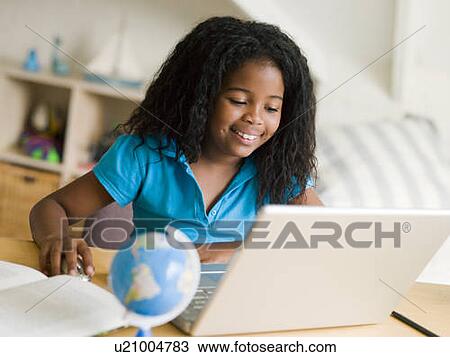 Young Girl Doing Her Homework On A Laptop View Large Photo Image Stock Image - Young Girl Doing Her Homework On A Laptop. Fotosearch