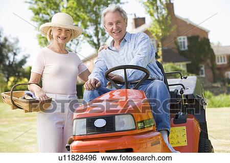 Couple outdoors with tools and lawnmower smiling View Large Photo Image Stock Photograph - Couple outdoors with tools and lawnmower smiling. Fotosearch