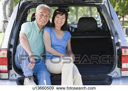 Couple sitting in back of van smiling View Large Photo Image Stock Photo - Couple sitting in back of van smiling. Fotosearch