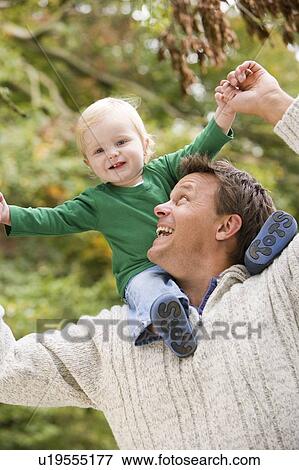Father giving baby son piggyback View Large Photo Image Stock Photo - Father giving baby son piggyback. Fotosearch
