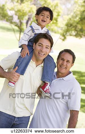 Picture - Grandfather with adult son and grandchild. Fotosearch