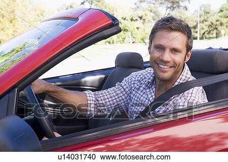 Man in convertible car smiling View Large Photo Image Stock Image - Man in convertible car smiling. Fotosearch