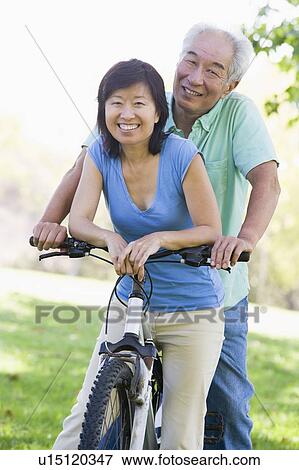 Stock Photo - Mature couple bike riding.. Fotosearch