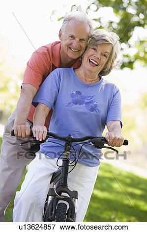 Senior couple on a bicycle View Large Photo Image Stock Photo - Senior couple on a bicycle. Fotosearch