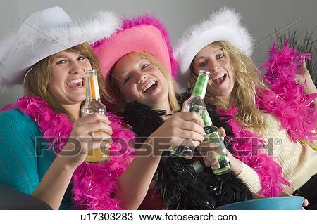 Stock Image - Dressed Up Teenage Girls Enjoying Drinks. Fotosearch