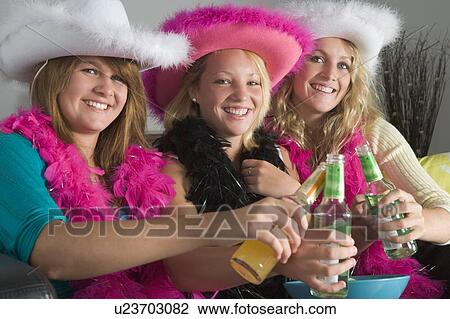 Stock Image - Dressed Up Teenage Girls Enjoying Drinks. Fotosearch