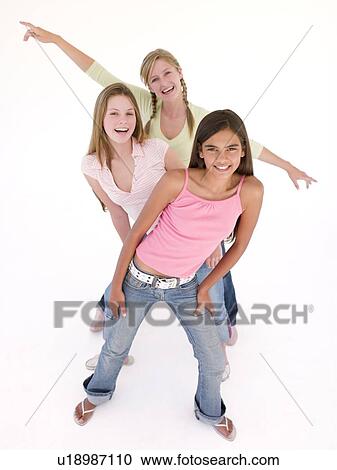 Three girl friends in a row smiling View Large Photo Image Stock Image - Three girl friends in a row smiling. Fotosearch