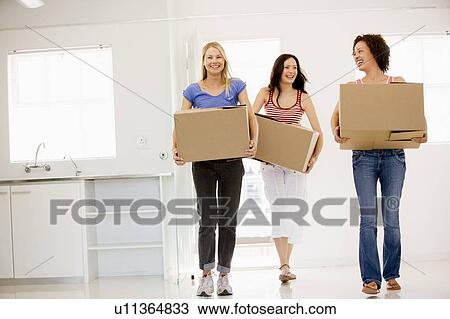 Three girl friends moving into new home smiling View Large Photo Image Stock Image - Three girl friends moving into new home smiling. Fotosearch